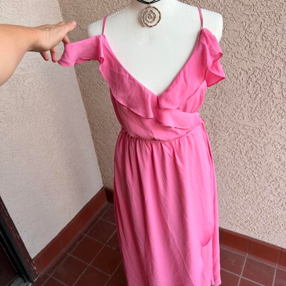 Pink maxi dress with ruffle details and adjustable straps.
